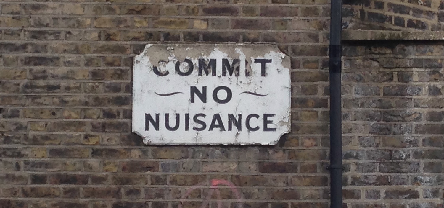 commit no nuisance sign on wall