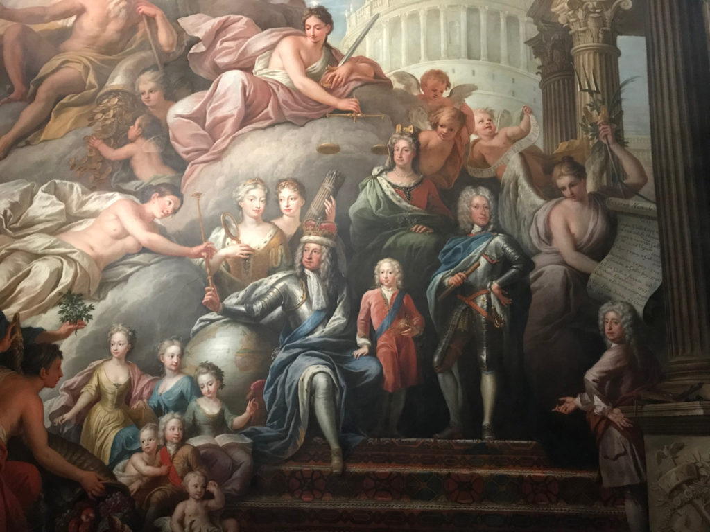 George I, the first of the Hanoverian kings with his son (later George II) standing in armour to his right. Bottom, by the column in a grey wig, is Thornhill himself.
